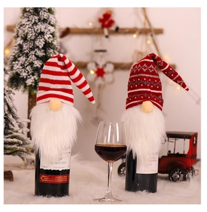 Close-up of festive knit Christmas gnome wine bottle covers with snowflake patterns
