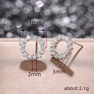 Minimalist silver circular hoop earrings with sparkling stones and size specifications