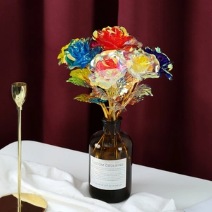 24k gold foil artificial rose with holographic petals in a brown glass vase