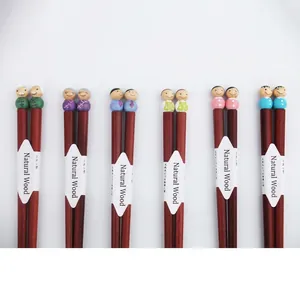6-pair set of cartoon family wooden chopsticks featuring cute doll heads on a white background