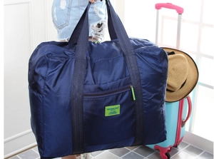 Dettaglio della borsa da viaggio pieghevole blu navy impermeabile con etichetta verde