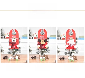 Detailed view of Merry Christmas felt door hangers with snowman, elk, and Santa dolls
