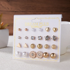 Close-up of 12 pairs assorted alloy stud earrings with pearls and rhinestones