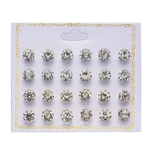 Close-up of 12 pairs of sparkling crystal stud earrings displayed on a white card
