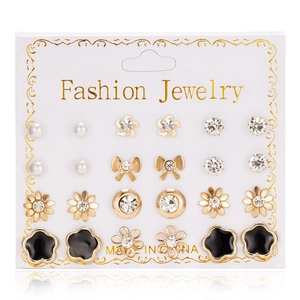 Close-up of 12-pair gold alloy earring set featuring pearls and rhinestones on card