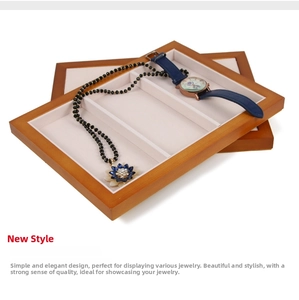 Detail of wooden jewelry display trays with beige compartments and stacking design