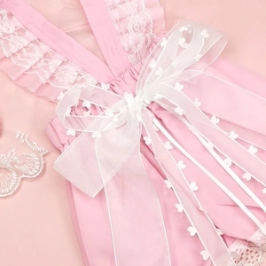 Detail of pink pet wedding dress with delicate white lace edges and large organza bow