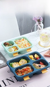 Divided lunch box detail showing separate compartments for rice, corn, and fruit variety