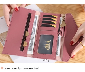 Detailed interior of pink trifold wallet with multiple card slots and heart tassel