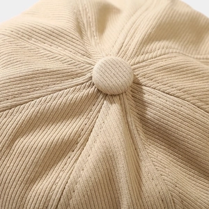 Retro khaki octagonal newsboy hat showing top button detail and twill fabric texture