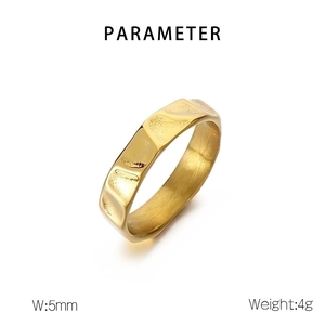 Detail view of 5mm wide golden ring with irregular hammered texture on white background