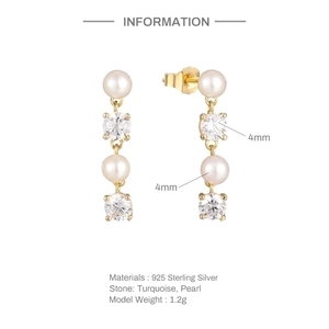 Macro detail of S925 sterling silver pearl drop earrings with elegant gold coating