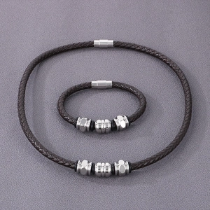 Detail of dark brown braided leather bracelet and necklace set with magnetic metal clasps