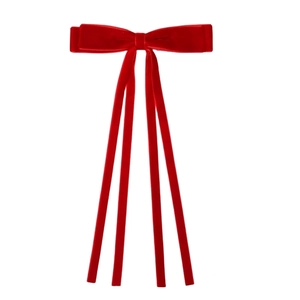 Detailed view of luxury red velvet bow hair clip with long elegant streamers on white background