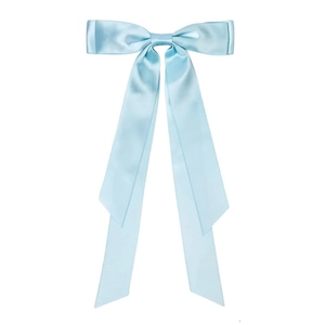 Detail of light blue satin hair bow with long flowing ribbons on white background