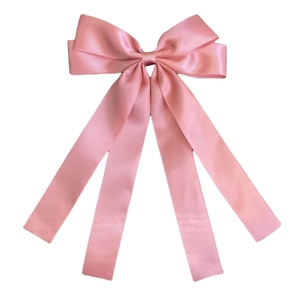 Detailed view of pink double-layered satin ribbon bow hairpin with long hanging streamers