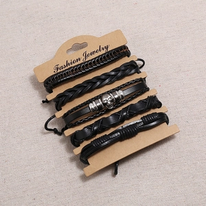 Vintage braided black leather bracelet set for men with metal skull charm on card