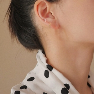 S925 sterling silver cross stud earring and gold hollow heart hoop worn on ear lobe