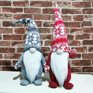 Detail of red and grey Christmas gnomes with snowflake knitted hats and white fur beards