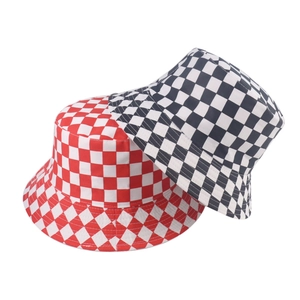 Close-up of black and white checkerboard bucket hats with canvas texture detail