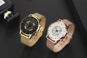 Detail view of gold and rose gold quartz watches with mesh straps and triple-dial design