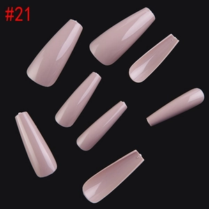 Macro detail of long coffin-shaped nude pink press-on nails with a glossy finish