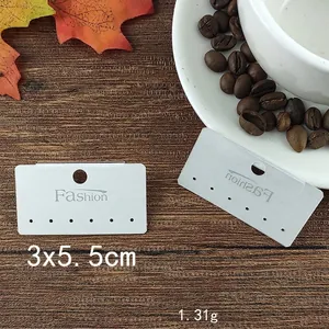 Detailed 3x5.5cm white jewelry display card showing holes and dimensions on wood