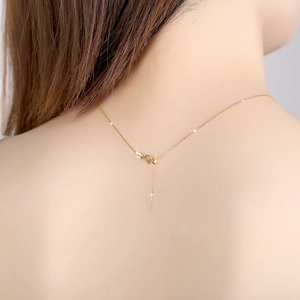 Detailed view of adjustable gold silver chain with a needle clasp on a model's neck
