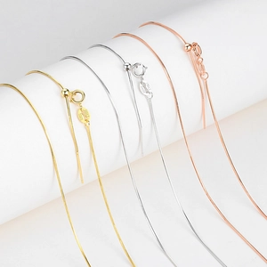 Detail of S925 sterling silver snake chains in gold, silver, and rose gold with adjustable beads