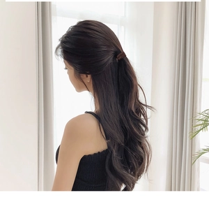 Close-up of a dark coffee brown seamless elastic hair tie styled in a half-up hairstyle