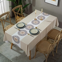 Detail of beige cotton linen tablecloth featuring blue and orange mandala patterns