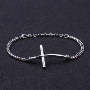 Minimalist silver stainless steel cross bracelet for men on a black textured surface