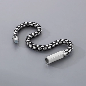 Detail of woven black leather cord bracelet with silver magnetic buckle for men