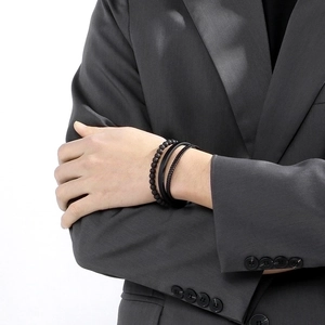 Close-up of black beaded lava stone and multi-layer leather bracelet set for men