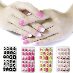 Detail view of artificial nail sets in pink gradient, black heart, and bowknot patterns