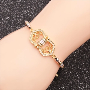 Adjustable gold bracelet with zircon inlays and hollow heart design on wrist