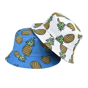Close-up of pineapple print sun hats showing high-quality stitching on cotton canvas