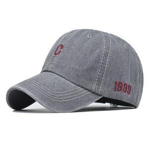 Detail of red embroidered letter C and 1999 on grey washed vintage cotton baseball cap