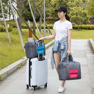 Foldable travel duffel bag with luggage sleeve and aircraft logo in dark gray