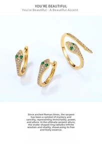 Detailed view of snake-shaped earring and ring set with green gems and white zircons