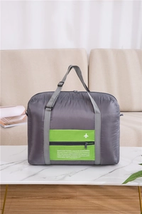 Close-up of large travel bag with green zipper pocket and global city list detail