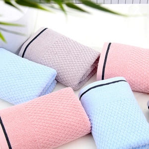 Detail of stacked honeycomb texture facial towels in assorted pastel macaron colors