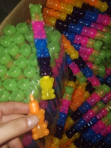 Close-up of colorful bear-shaped stackable highlighters in a bulk packaging box