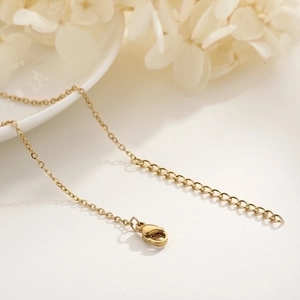 Detailed macro view of 18k gold plated cable chain with secure lobster clasp and extender