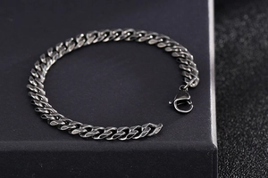 Close-up of vintage gun-black Cuban link bracelet for men with lobster clasp detail