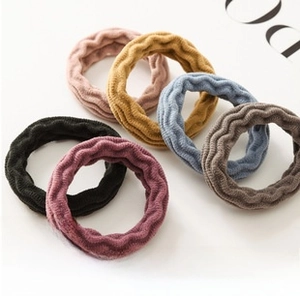 Detail of six high-elastic wave-textured hair ties in assorted colors for children