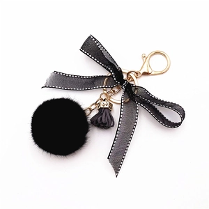 Cute black faux fur pompom keychain with lace bow and gold clasp for handbags