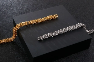 Close-up of hip hop crown necklaces in gold and silver finish with detailed links