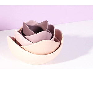 Detail view of four-piece nesting ceramic lotus bowls in gradient purple tones