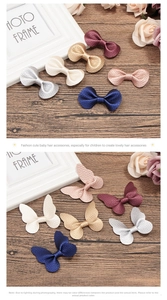 Detailed view of litchi texture butterfly and bow hair clips in assorted colors